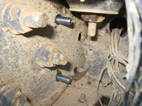 1978 Ford Bronco - A close-up view of a vehicle's rusty frame shows new bolts and a bundle of wires.