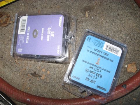 1978 Ford Bronco - Two packages of Dorman hardware, one containing washers and the other containing bolts, sit on a concrete surface.