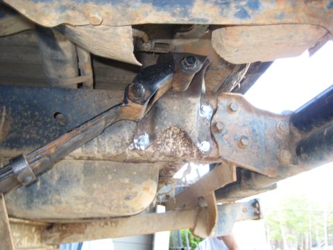 1978 Ford Bronco - Close-up view of heavily rusted vehicle suspension components and mounting hardware.
