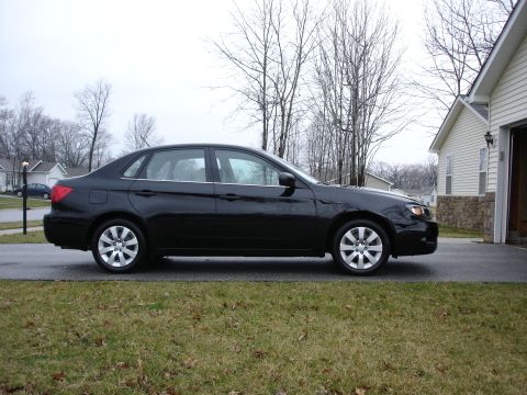 2008 Subaru Impreza - Side profile of a black 2008 Subaru Impreza sedan parked in a driveway.
