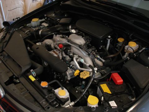 2008 Subaru Impreza - The engine bay of a 2008 Subaru Impreza is pictured, revealing the boxer engine and associated components.