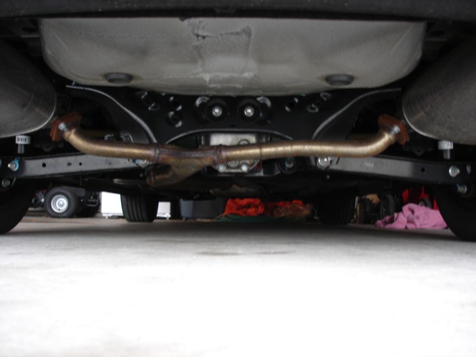 Underside view of a vehicle's exhaust system and rear suspension components