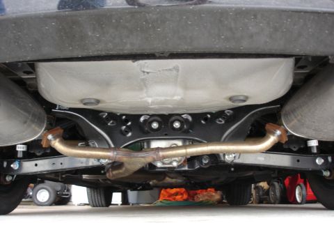 2008 Subaru Impreza - The rear suspension and exhaust system of a vehicle are visible from below.