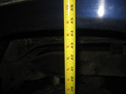 1978 Ford Bronco - Measuring suspension components on a blue vehicle.