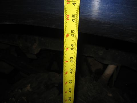 1978 Ford Bronco - Measuring vehicle suspension height with a tape measure.