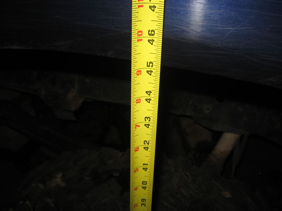Measuring tape against vehicle suspension components, showing approximately 45 inches