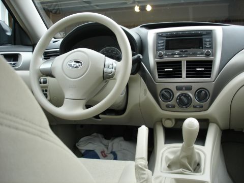 2008 Subaru Impreza - The interior of a 2008 Subaru Impreza is shown, the steering wheel, dashboard, and gear shifter.