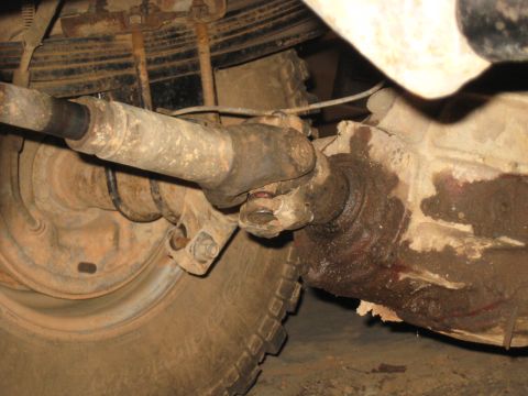 1978 Ford Bronco - Underbody photograph of a driveshaft joining the differential pinion, not a technical document.