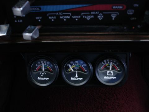 1987 Ford LTD Crown Victoria - Three Auto Meter Autogage instruments, oil pressure, water temperature and voltmeter, mounted in a black under-dash triple pod below the fa…