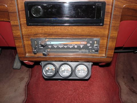 1987 Ford LTD Crown Victoria - Interior center-stack view of a woodgrain dash with an empty radio bezel, the factory slide-lever heater/AC control panel with missing knob…