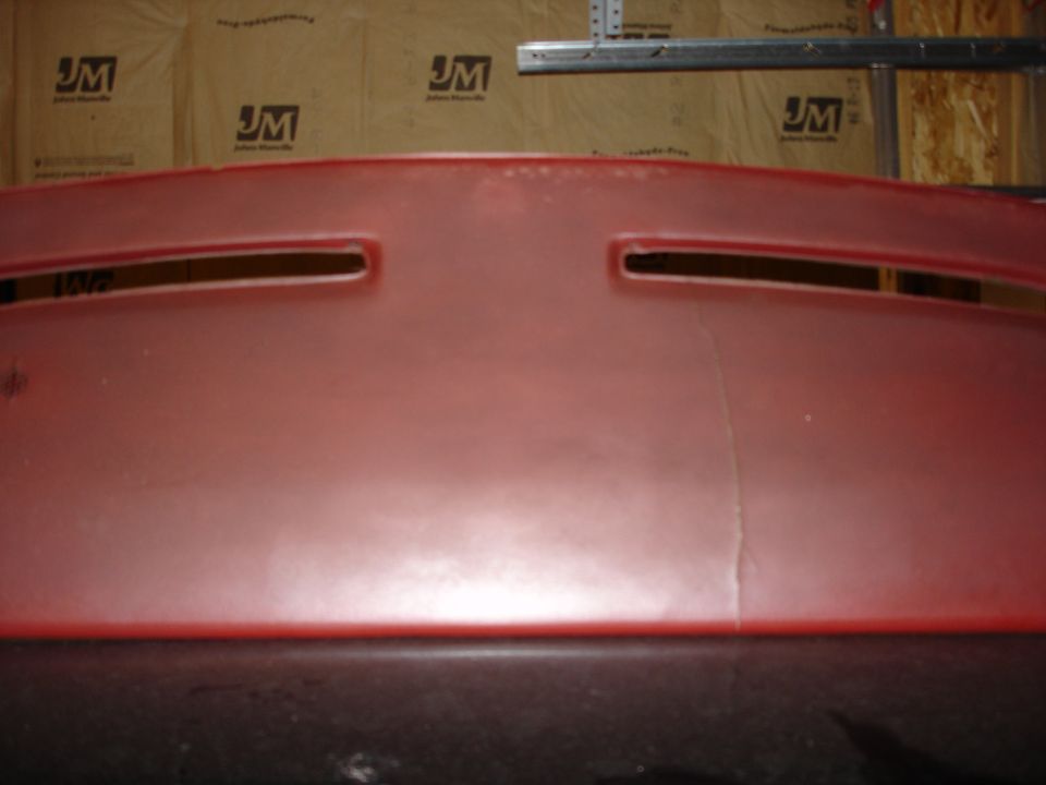 Red dashboard with two vents and a crack
