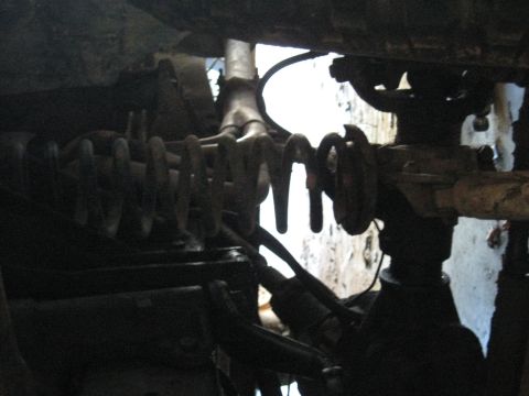 1978 Ford Bronco - Underbody photograph of coil springs and axle components, not a technical document.