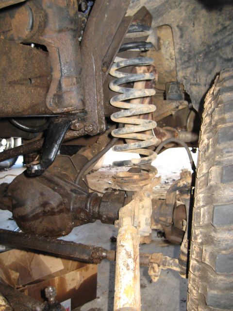 1978 Ford Bronco - Underbody photograph of the coil-spring front suspension and differential, not a technical document.