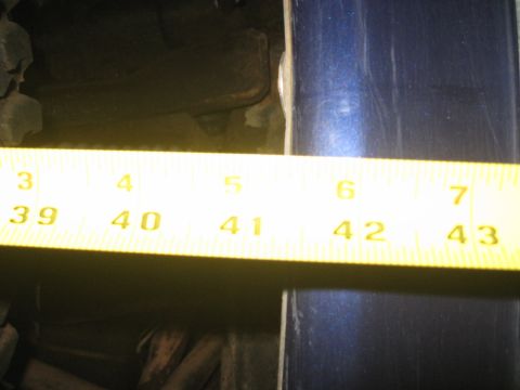 1978 Ford Bronco - Close-up photo of a tape measure held against a vehicle body, not a technical document.