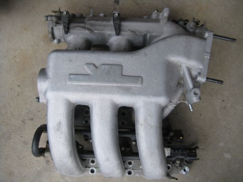 1993 Ford Probe - Aluminum intake manifold with four runners, likely from a car engine.