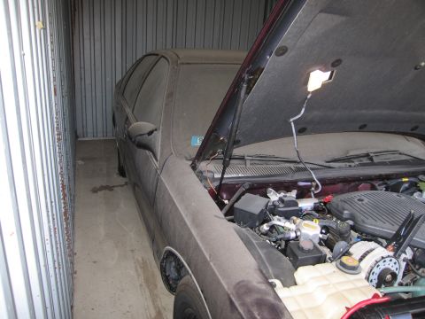 1991 Ford LTD Crown Victoria - Photograph of a car in storage, not a technical document.