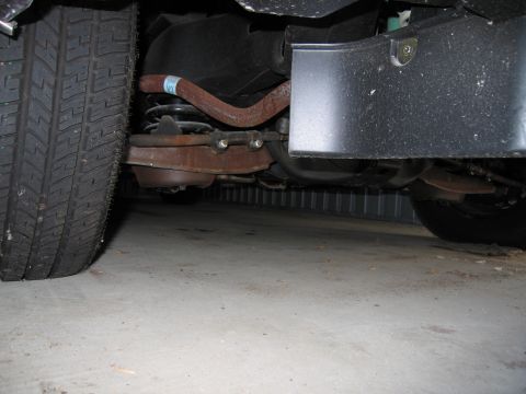 1991 Ford LTD Crown Victoria - Photograph of vehicle undercarriage components, not a technical document.