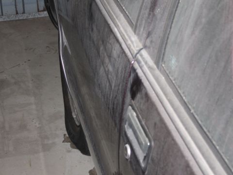 1991 Ford LTD Crown Victoria - Photograph of a car's side body, not a technical document.