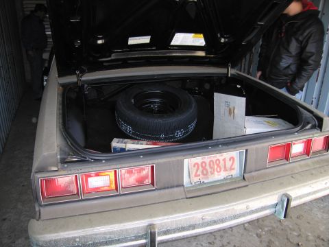 1991 Ford LTD Crown Victoria - Photograph of an open trunk and rear of a car, not a technical document.
