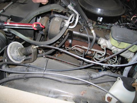 1991 Ford LTD Crown Victoria - Photograph of an engine compartment with hoses, not a technical document.