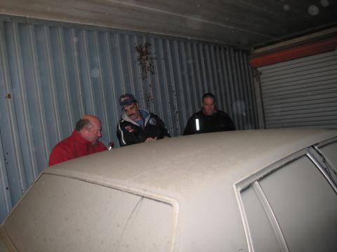 1991 Ford LTD Crown Victoria - Photograph of people inspecting a car, not a technical document.