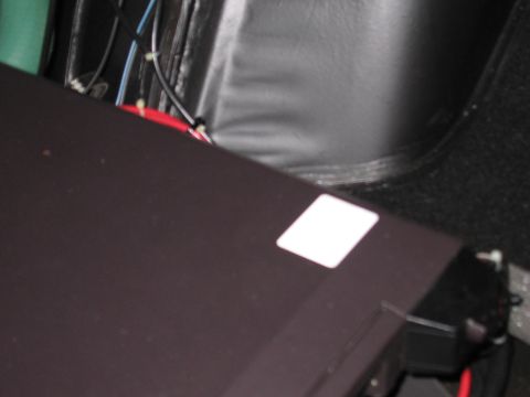 1991 Ford LTD Crown Victoria - Photograph of a black amplifier or electronics box with wiring in a vehicle trunk, not a technical document.