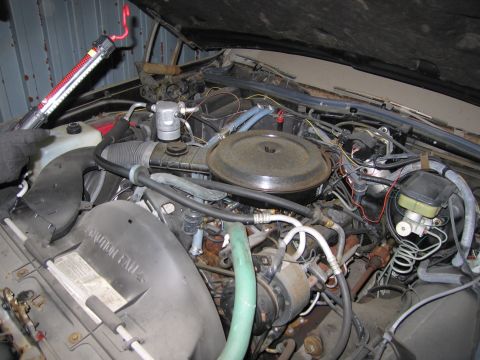 1991 Ford LTD Crown Victoria - Photograph of an engine bay showing the air cleaner, hoses, and wiring, not a technical document.