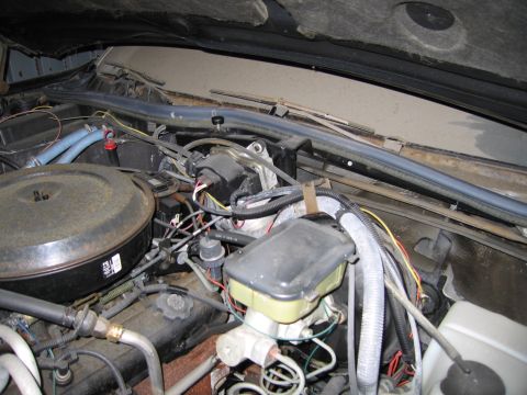 1991 Ford LTD Crown Victoria - Photograph of an engine bay showing the brake master cylinder, air cleaner, and hoses, not a technical document.