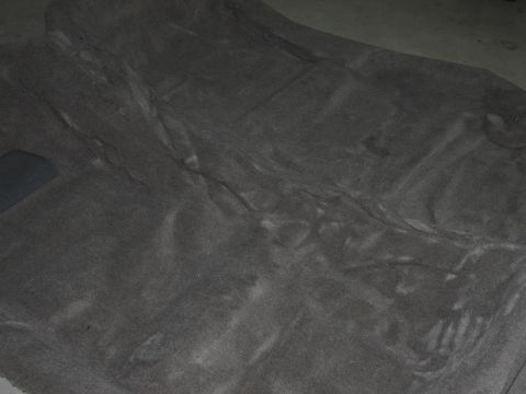 1991 Ford LTD Crown Victoria - Photograph of a gray automotive carpet or floor liner laid out flat, not a technical document.