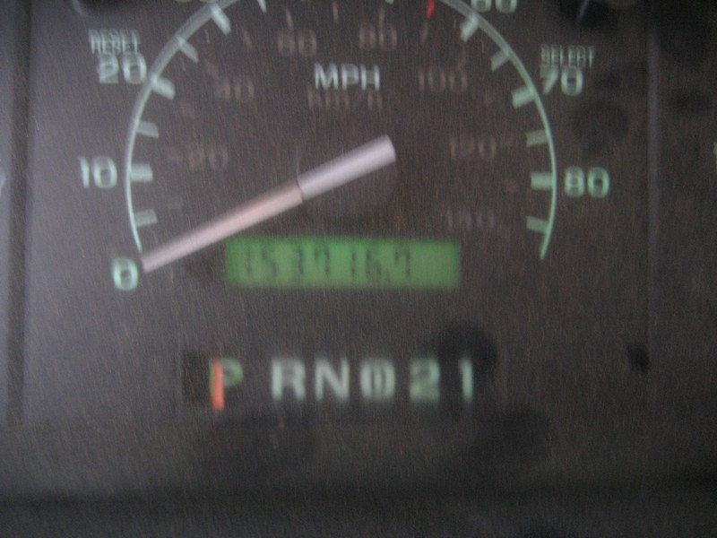 Close-up of a vehicle dashboard showing a speedometer and gear indicator for Park.