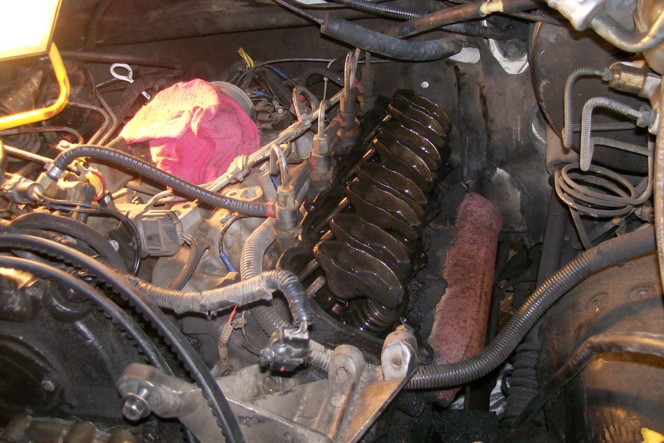 Engine bay of a 1992 Ford C-350 showing valve covers, fuel injectors, and wiring.