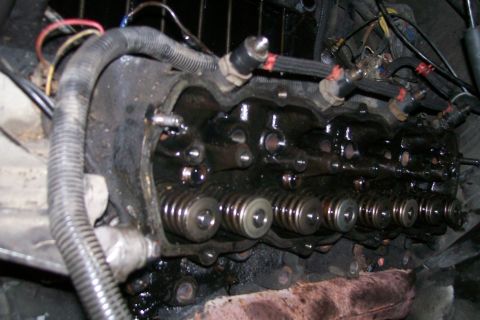 1992 Ford C-350 (Centurion Conversions) - Engine cylinder head with valves and fuel injectors visible, likely during repair.