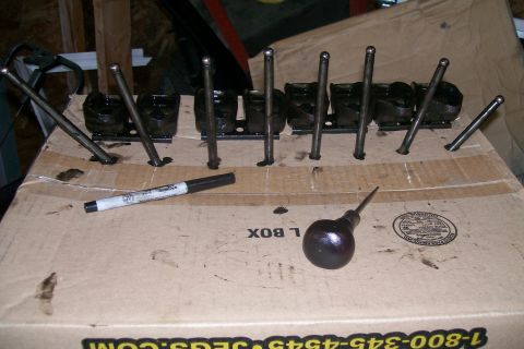 1992 Ford C-350 (Centurion Conversions) - Engine valve train components are organized on a cardboard box, ready for assembly or repair.