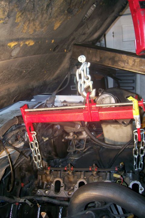 1992 Ford C-350 (Centurion Conversions) - Engine hoist in use to support the engine block during a repair procedure.