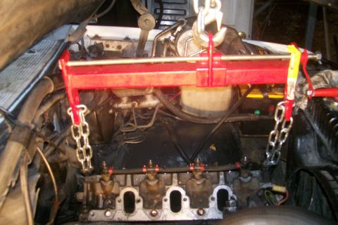 1992 Ford C-350 (Centurion Conversions) - Engine hoist in use during engine work, focusing on the cylinder head area.