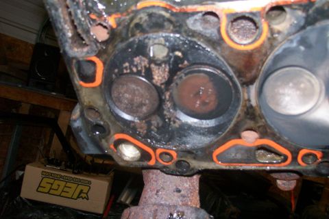1992 Ford C-350 (Centurion Conversions) - Close-up of an engine cylinder head, showing valves and gasket. A JEGS box is visible in the background.