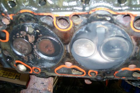 1992 Ford C-350 (Centurion Conversions) - Close-up of an engine cylinder head with valves and gasket material visible.