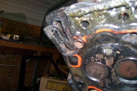 1992 Ford C-350 (Centurion Conversions) - The engine cylinder head shows significant damage to the gasket area, indicating a blown head gasket.
