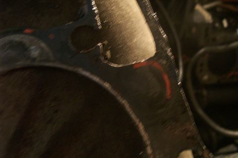 1992 Ford C-350 (Centurion Conversions) - Close-up view of a damaged engine head gasket, showing signs of wear and tear.