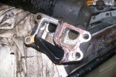 1992 Ford C-350 (Centurion Conversions) - Close-up of a removed engine component showing old gasket material and fluid buildup.