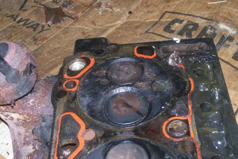 1992 Ford C-350 (Centurion Conversions) - Close-up view of a used engine cylinder head, showing wear and gasket material.
