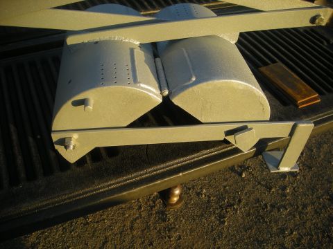 1991 Ford Bronco - Dual exhaust tips and their mounting hardware are shown in a truck bed.