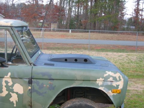1992 Ford Mustang - A vintage Ford Bronco with a custom hood scoop is shown from the front passenger side.