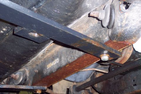 2001 Ford Crown Victoria - Close-up view of the undercarriage, highlighting rusted suspension components and aftermarket additions.