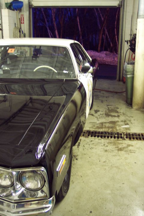2001 Ford Crown Victoria - Front quarter view of a 2001 Ford Crown Victoria police car parked indoors.