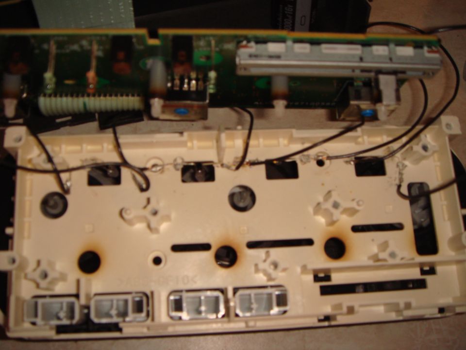 I added four LEDs in the square holes at the top of the climate control and wired them individually to the existing lights.  To anchor them, use a hot soldering iron to melt the LED wire into the plastic.

I originally tried to do all four LEDs in series, but after asking my EE uncle why it didn't work, I got a napkin lesson on forward voltage and LEDs.  I knew I should have paid better attention in my E&M class.