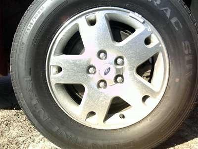 2006 Ford Escape - A close-up view of a 2006 Ford Escape wheel, showing the tire and rim details.