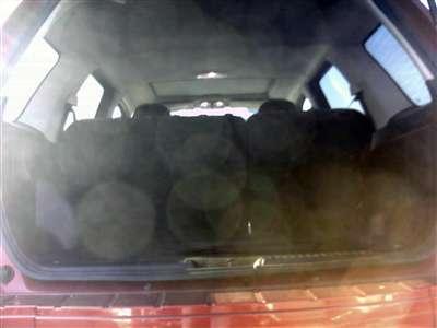 2006 Ford Escape - The rear cargo area of an SUV is visible, packed with items. The Supermotors.net logo is present in the lower right corner.