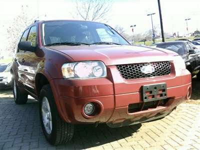 2006 Ford Escape - This red Ford Escape SUV is shown from a 3/4 front angle.