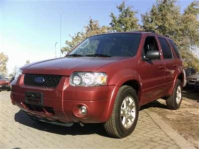 2006 Ford Escape - Red Ford Escape SUV parked outdoors, showing its front 3/4 view.